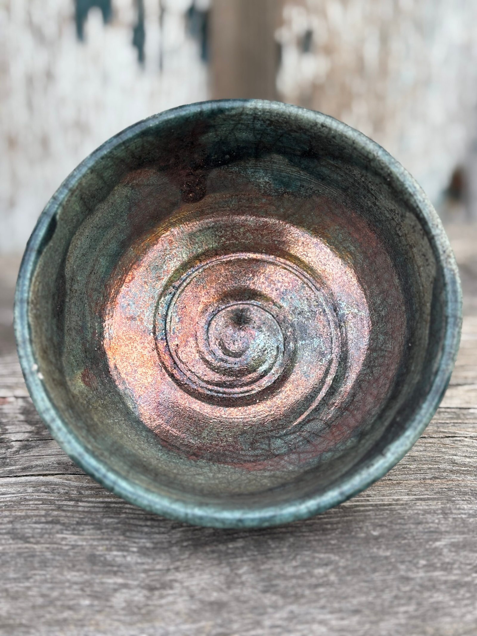 Shiny raku-fired ceramic piece with crackled glaze